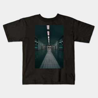 A Long Hallway With a Light Kids T-Shirt